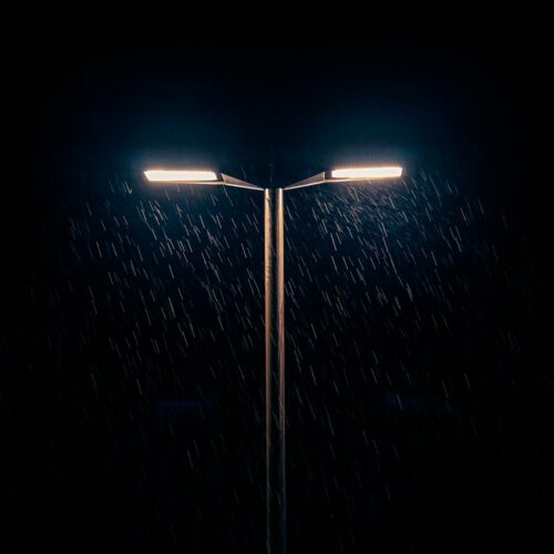 a street light in the rain at night
