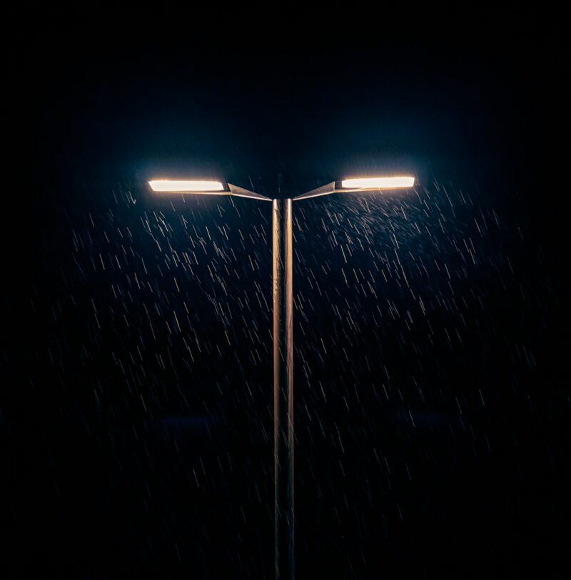 a street light in the rain at night